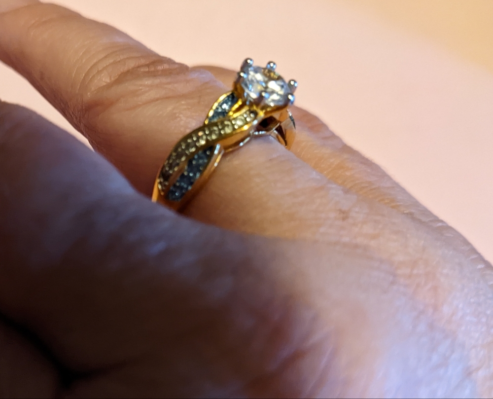 14k plated over sterling silver.  Simulated diamond and Blue Topaz ring.